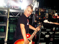 Tobin Kravchenko is seen here backstage at a Foo Fighter’s concert tuning singer-guitarist Dave Grohl’s Gibson Les Paul.