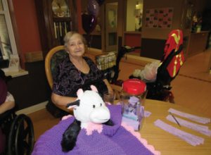 Westmount Gardens resident Marguerite Sivak is pictured here with the "purple buddy" she made for the London, Ont. long-term care home's Purple Day Challenge.